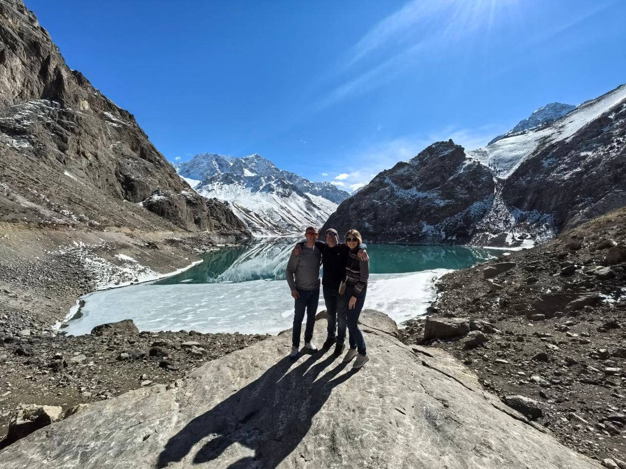 Travellers at a mountain lake on a day tour